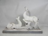 two figurines of animals that are sitting on a table