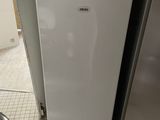 a white refrigerator and a silver refrigerator in a kitchen