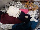 a bag full of clothes that is sitting on the floor