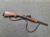 a rifle that is laying on the floor