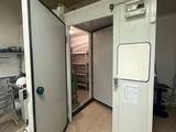 a room with a refrigerator and a table in it