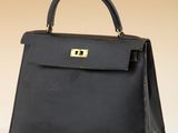 a black leather handbag on a white surface