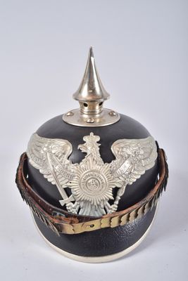 an image of a black and silver military helmet with a silver eagle on it
