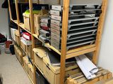 many boxes and boxes stacked on a shelf in a room
