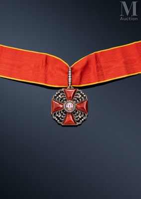 a close up of a red ribbon with a cross on it