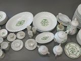 many plates and cups and bowls on the table