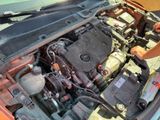 a man working on the engine of a car