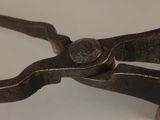 a close up of a pair of pliers on a table
