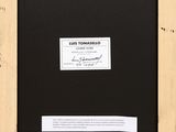 a framed photograph of a black and white picture with a label on it