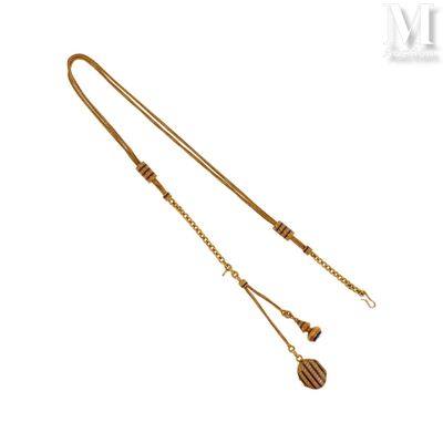 une image représentant un collier en or composé d'une longue chaîne et de deux breloques