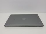 the dell laptop is sitting on a table with a white background