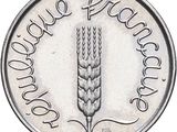 an image of a silver coin with a picture of a plant on it