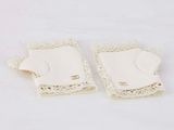 pair of white crocheted lace fingerless gloves on white background