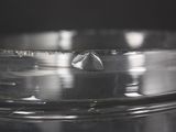 close up of a metal container with a water droplet in it