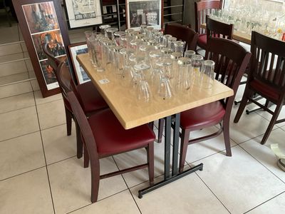 many empty glasses on a table in a restaurant