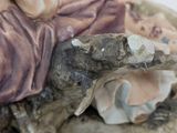 a figurine of a woman sitting on a shell