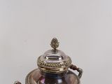 a silver and blue vase with a bird on it