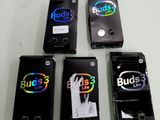 Quatre téléphones portables sont alignés sur une table ; ils sont tous munis d'un autocollant.