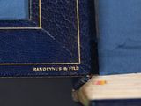 a blue book with a pencil sticking out of it