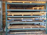 a pile of wood sitting on the ground in front of a building