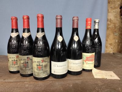 six bottles of wine are lined up on a wooden table