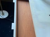 a desk with a drawer on it and a lamp on top of it