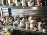 many different types of pottery on the shelves in this room