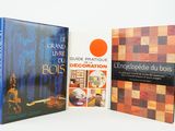 two books are sitting on a white surface, one is a chess board and the other is a book