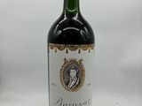 the bottle of red wine is sitting on the table
