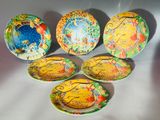 six decorative plates are arranged on a table with a white background