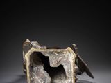 an image of a sculpture of a dog inside of a box