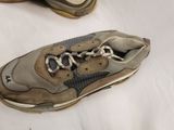 a pair of shoes that are on a bed