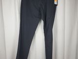 a pair of black pants hanging on a white curtain