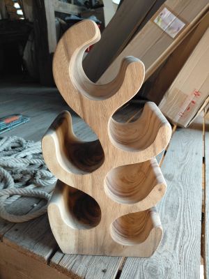 a wooden wine rack that is on a wooden table