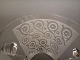 a glass bowl with a decorative design on it