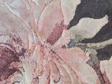 a close up of a rug with flowers on it