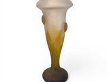 a glass vase that is sitting on a stand