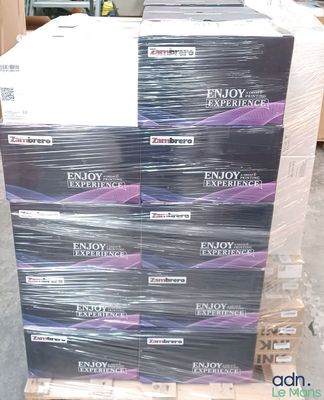 boxes of enjoy experience condoms stacked on a pallet in a warehouse