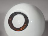 a white ball with a brown ring on top of it