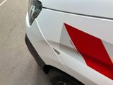 a white car with a red stripe on the side of it