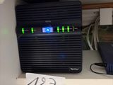 a picture of a computer on a shelf with a lot of wires