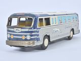 a blue and white bus that is on a white surface