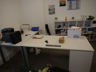 a white desk with a laptop on it in a room