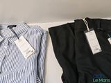two men ' s shirts that are sitting on a shelf