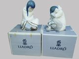 two figurines of a man and a woman sitting on a box