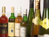 many bottles of wine sitting on a shelf next to each other