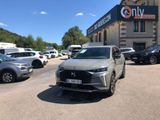 many cars parked in front of a building in a parking lot
