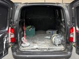 a van that is parked in a parking lot with its doors open