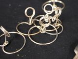 a bunch of silver rings and a pair of scissors on a table
