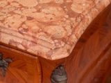 a marble top on the top of a wooden dresser